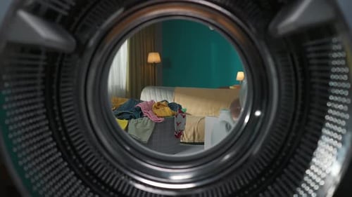 View From Inside the Empty Washing Machine with an Opened Door Into the Living Room Slow Motion