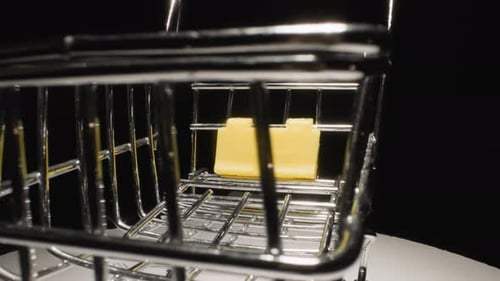 Metal Grid Trolley with Yellow Stand on White Surface Rotates