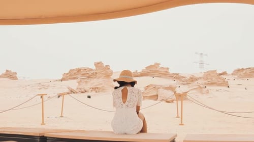 Tourist Sit Hide From Sun By Fossil Dunes In Uae