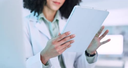 Medical Professional Using Tablet in Bright Lab