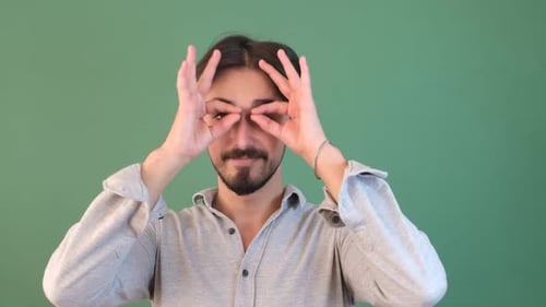 Young Adult Man Makes Circles Around Eyes