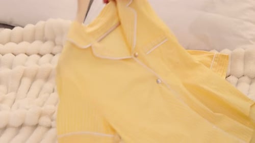 Yellow Striped Pajamas with Sleep Mask on Bed