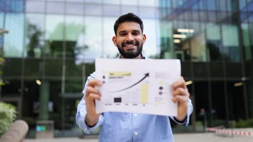 Businessman Holding a Business Chart