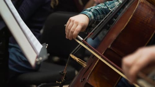 Musician Playing Violin on the Symphony Hall. Hands Play a Musical Instrument