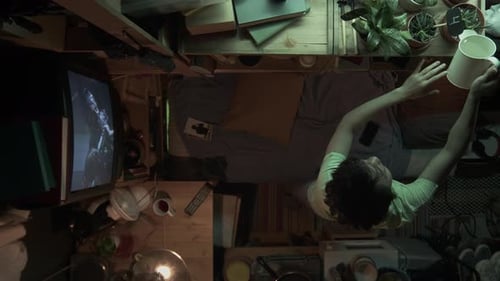 Top View of Chinese Woman Watering Succulent Plants in Micro Flat