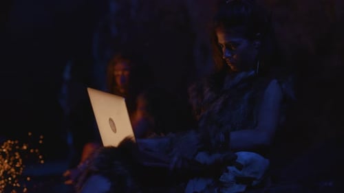 A Mystical Scene Depicting a Woman Engaged in Work By the Warm Glow of Firelight Inside a Cave