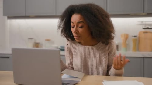 Woman Working at Laptop in Kitchen Video Call