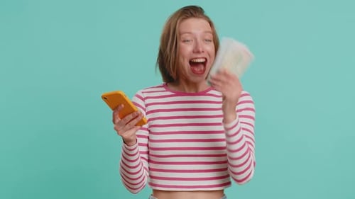 Woman Celebrates Winning Money on Phone