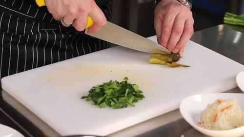 chef cutting vegetables in kitchen