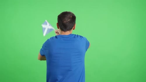 Rear View of a Man Waving a Scottish Pennant