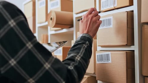 The Process Of Work Of A Storekeeper In A Cargo Warehouse Warehouse Worker Holds A Tablet His Hands