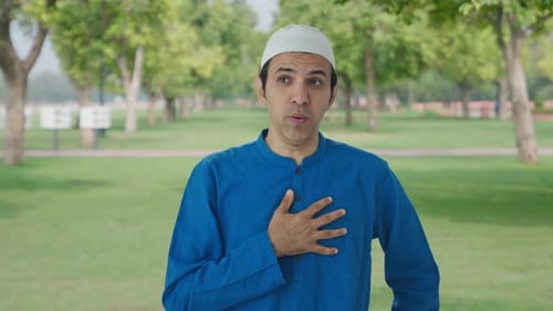 Sick Muslim man suffering from Cold and cough in park