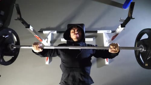 Strong Sporty Man Doing Bench Press Workout with a Barbell at Fitness Centre Young Sportsman Doing