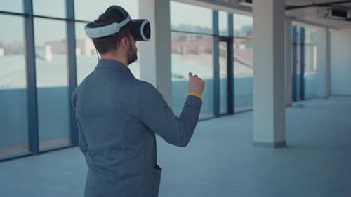 Man Using VR Headset in Modern Office Space