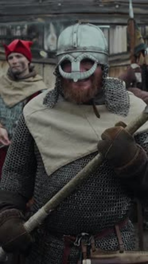 Portrait of Fierce Red-Haired Warrior Holding Axe Guarding Fort with Comrades