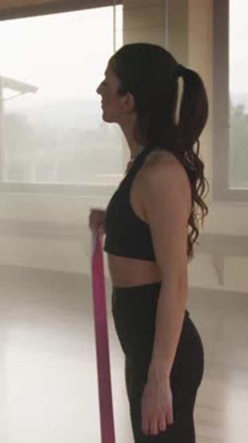 Woman Working Out with Resistance Band Indoors