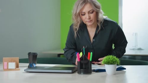 Real Estate Professional Prepares for Work with Coffee and Laptop