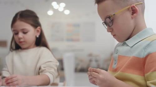 Children Playing with Modeling Clay at School