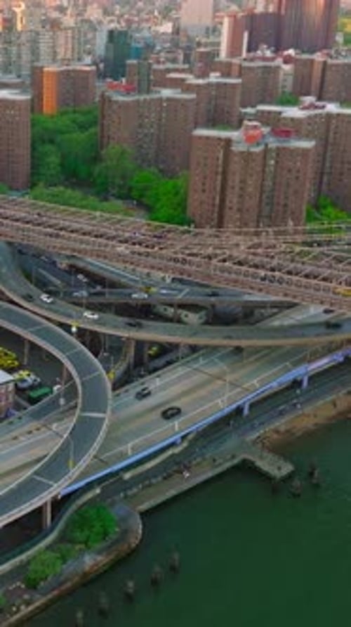 Numerous roads passing under the Brooklyn Bridge. Dense architecture of New York city