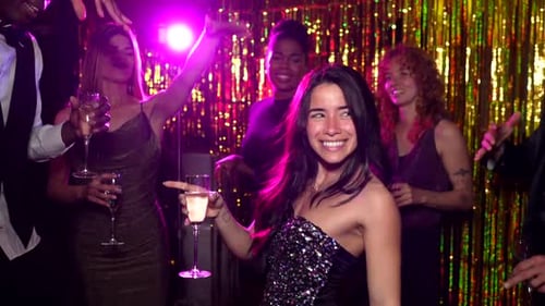 Stylish Friends Dancing at Birthday Party with Champagne