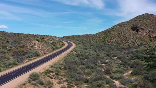 Push in on a lonely desert highway snakes through the rugged Sonoran Desert in the Tonto National Fo