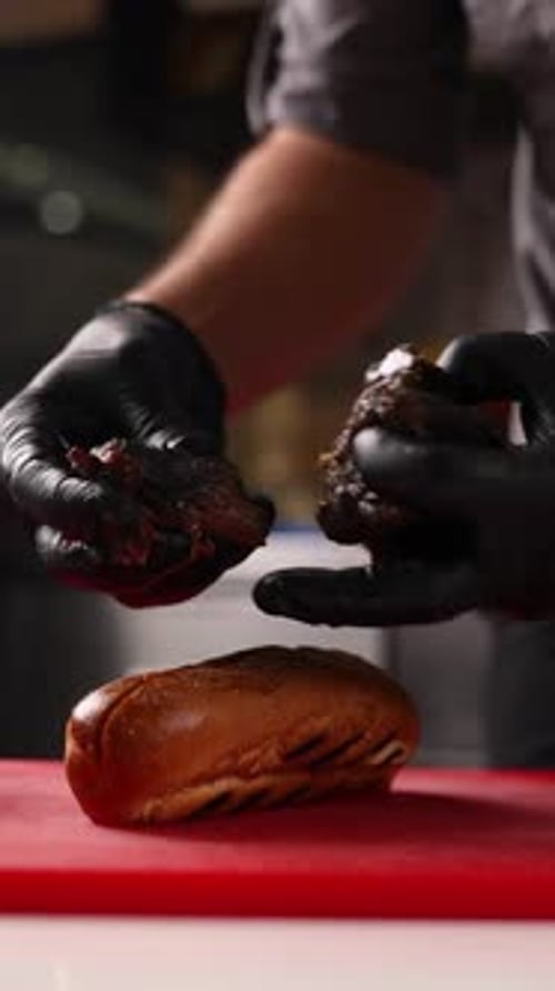 A chef prepares delicious hot dogs in a restaurant.