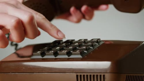 Hand Holding Old and Retro Telephone Vintage Phone Headset Isolated on Grey Studio Background Woman