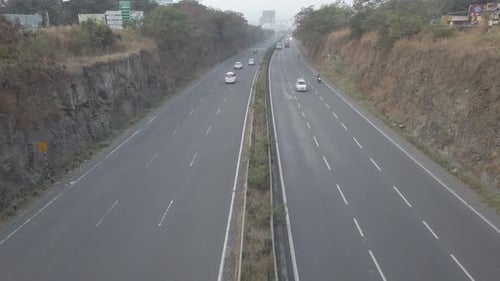 Multi-lane Mumbai Bangalore highway traffic near Pune, road travel in India