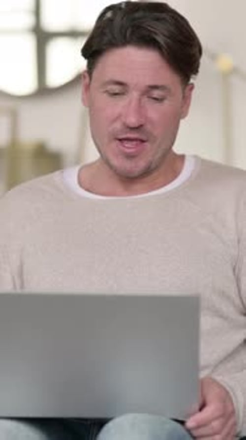 Man Video Calling on Laptop from Home