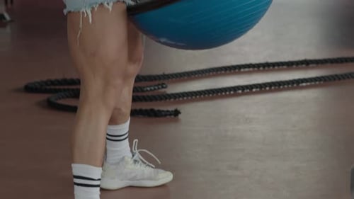Homme effectuant un exercice de burpee avec un entraîneur d'équilibre au gymnase