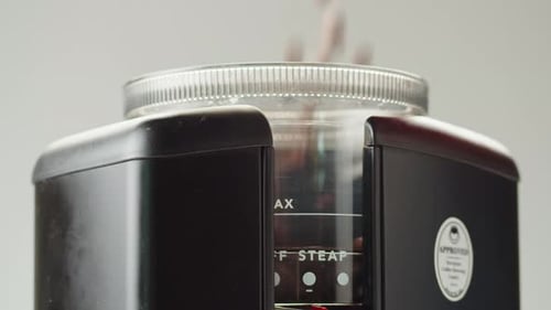 Electric Coffee Grinder Preparing to Grind Coffee in Shop Barista Making Specialty Drink