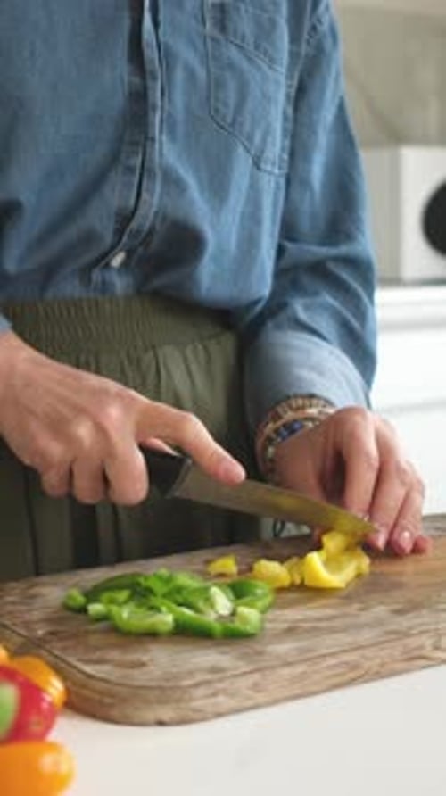 Woman Slicing Yellow And Green Pepper