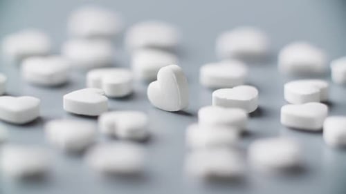 Heart Shape Pills Rotating on Table Pharmaceutical Market Medication Treatment
