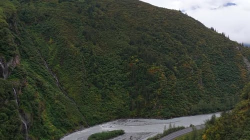 Aerial view of river between green mountains, United States.