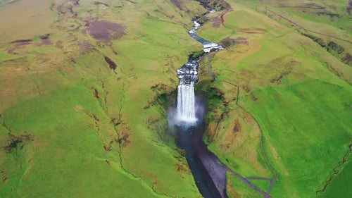 Skogafoss waterfall during summer - Pullback aerial video - Ring Road Iceland in 4k