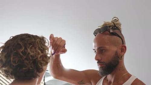 Gay Professional Artist Applying Makeup on Female Model in Studio
