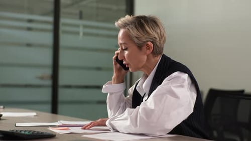 Woman Talking on Phone in Office Environment