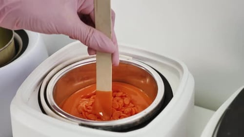 Depilatory Master Stirs Granular Wax Melter