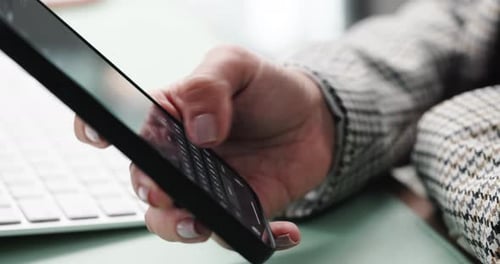 Hand Typing on Cell Phone in Office Setting