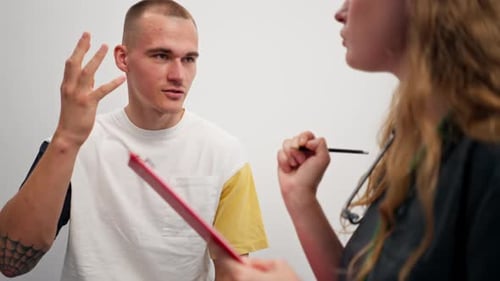 Close Up in a Modern Clinic in a Small Therapist s Office a Young Girl Doctor with a Stethoscope is