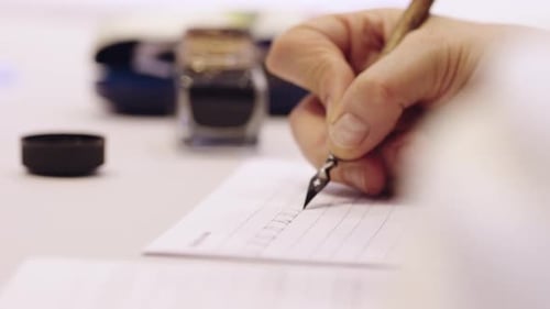 Handschrift mit schwarzem Tintenstift der alten Schule auf weißem Blatt Papier