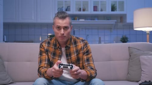 Excited Young Man Playing Video Game at Home