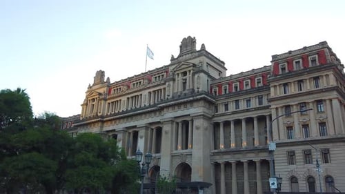 Palace of Justice, national building, Argentine flag waves over sunset skyline, establishing shot of
