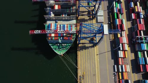 Container ship in export and import business and logistics. Shipping cargo to harbor by crane. Water