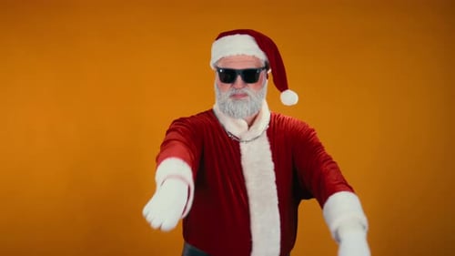 Cool Santa Claus Dancing against Orange Background