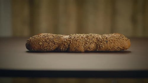 Loaf of Seeded Bread on Table