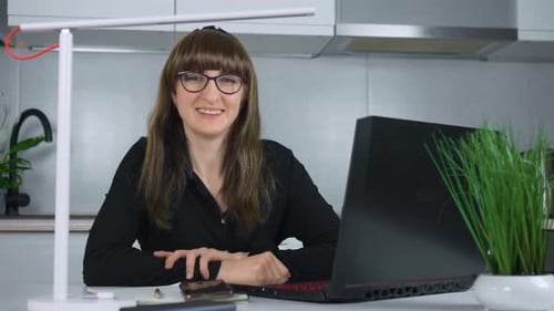 Smiling Woman At Desk Working With Laptop