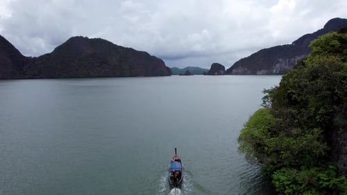A Longtailed Thai Boat Sails Among the Islands