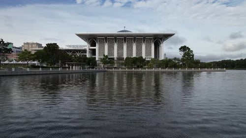 Aerial drone over lake Mosque Putrajaya Malaysia dolly in tilt up shot