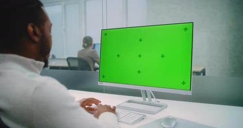 African American Financial Expert Works on Personal Computer with Green Screen Chromakey